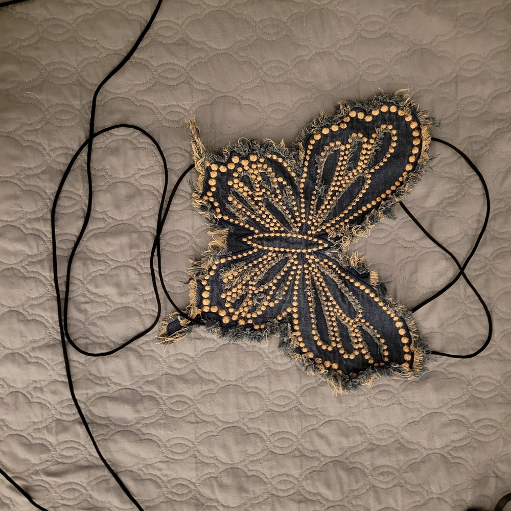 A distressed beaded denim butterfly top
